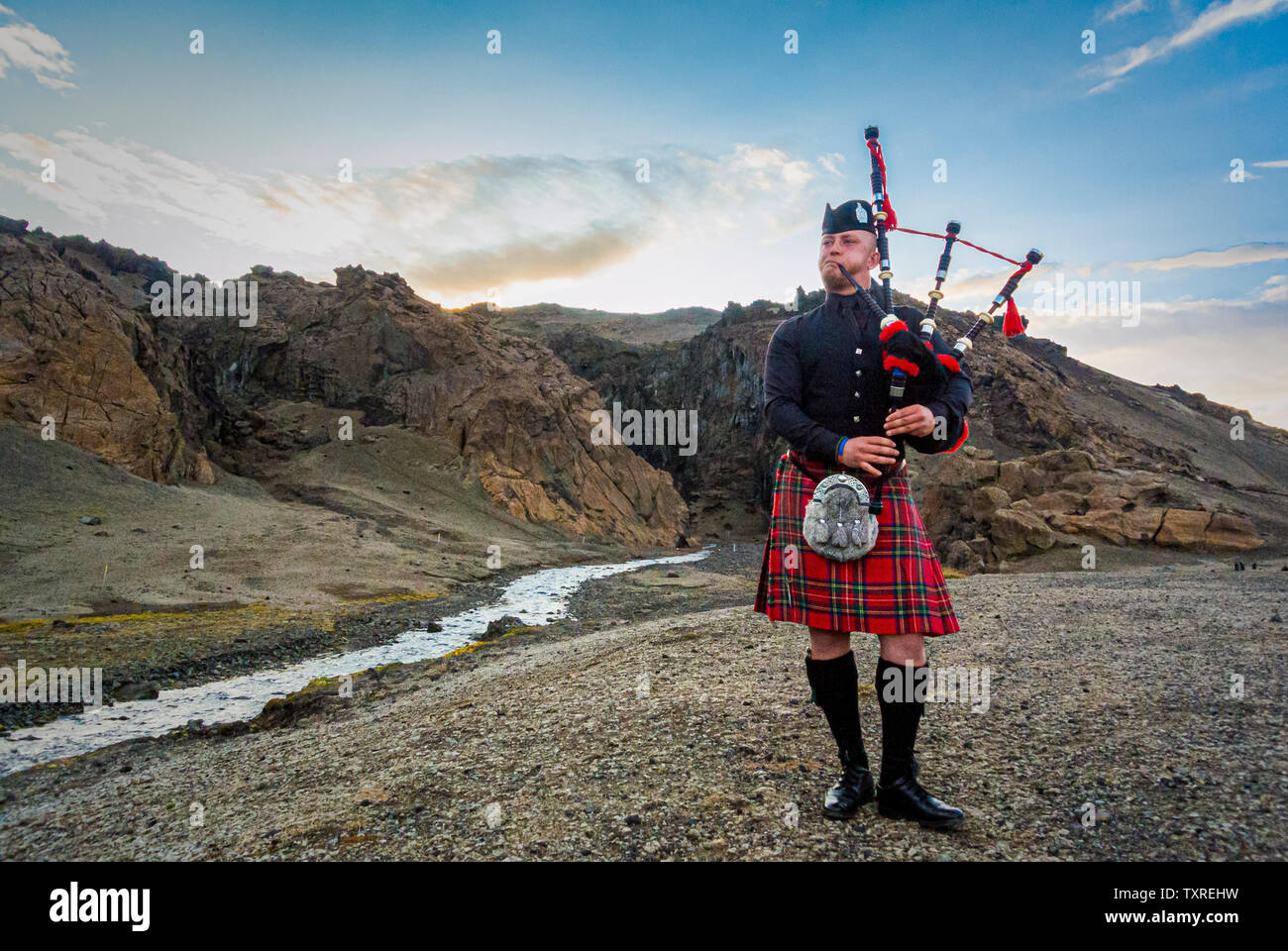 Scottish piper in Icelandic Desert. Stock Photo