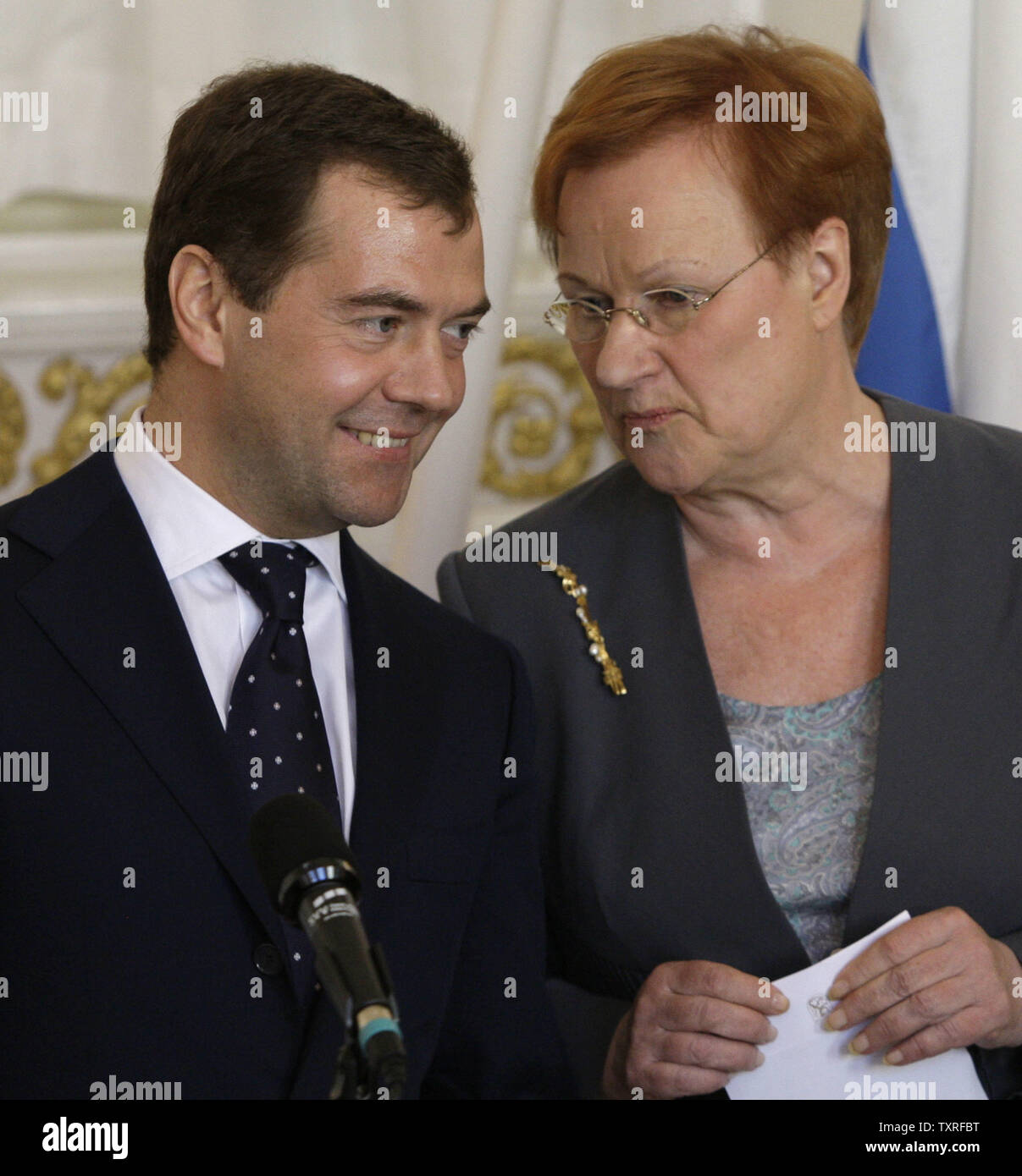 Russian President Dmitry Medvedev (L)and his Finnish counterpart Tarja Halonen chat during a joint news conference in Helsinki on April 20, 2009. Russia responded cautiously on Monday to U.S. President Barack Obamas plans for a nuclear-free world, saying a number of conditions would need to be met for the vision to become reality. (UPI Photo/Anatoli Zhdanov) Stock Photo