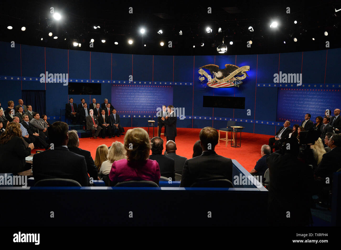Republican nominee Mitt Romney listens to President Barack Obama at the second Presidential Debate, Town-Hall style, at Hofstra University on October 16, 2012 in Hempstead, New York.     UPI/Pat Benic Stock Photo