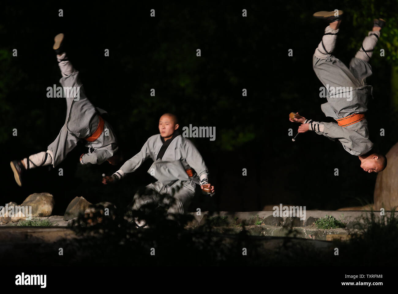 Shaolin kung fu monks participate in a performance in the Shaolin Zen Music Ritual in front of hundreds of tourists in Sanmenxia, Henan Province, on May 28, 2017.  The performance explains the tenets of Buddhism with monks, kung fu monks and dancers joining together in a high-end, technology-heavy show in the mountains surrounding the Shaolin Temple.        Photo by Stephen Shaver/UPI Stock Photo