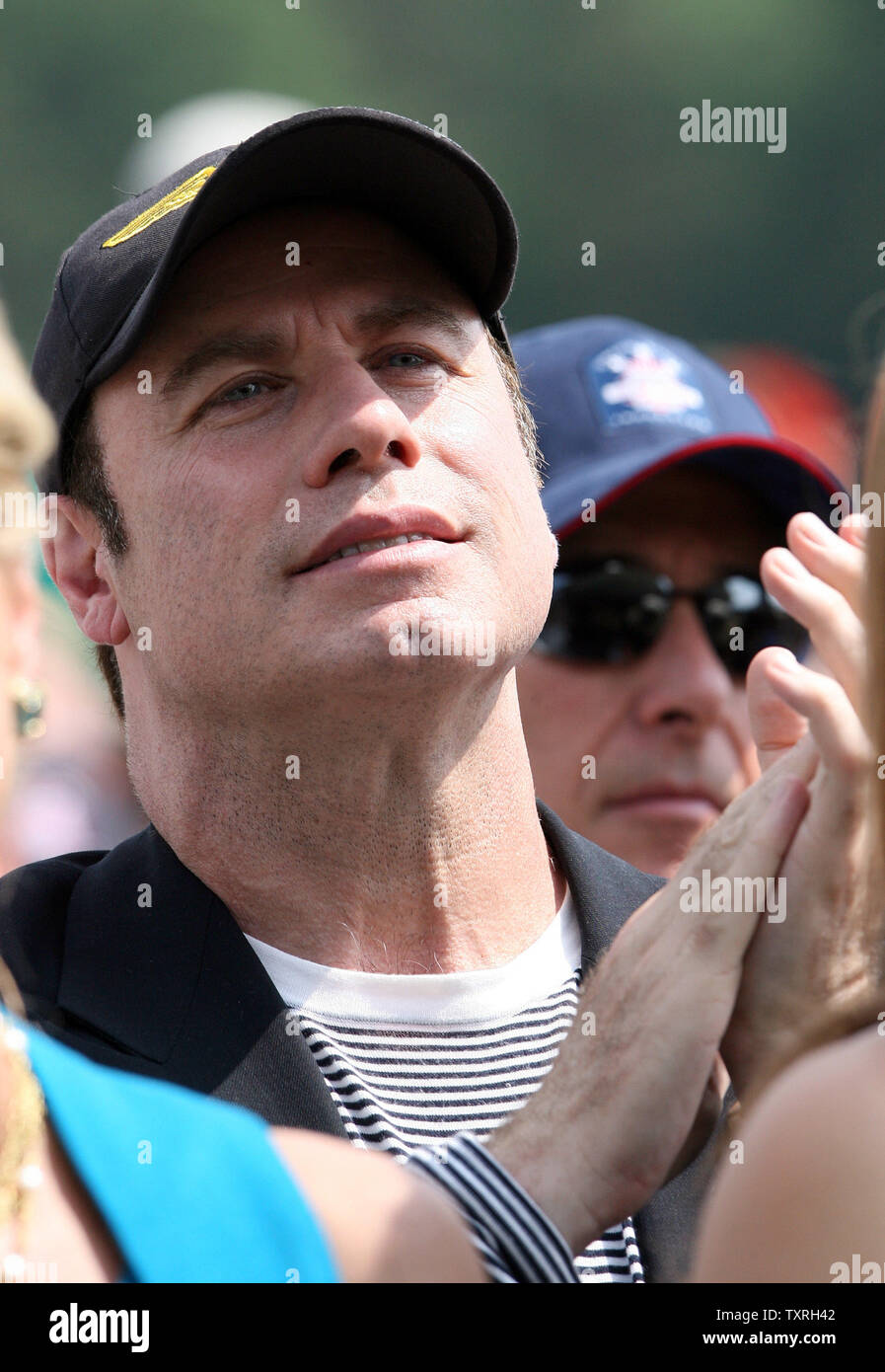 Actor John Travolta claps for National Baseball Hall of Fame's newest member, friend Cal Ripken Jr., during induction ceremonies in Cooperstown, New York on July 29, 2007.  (UPI Photo/Bill Greenblatt) Stock Photo