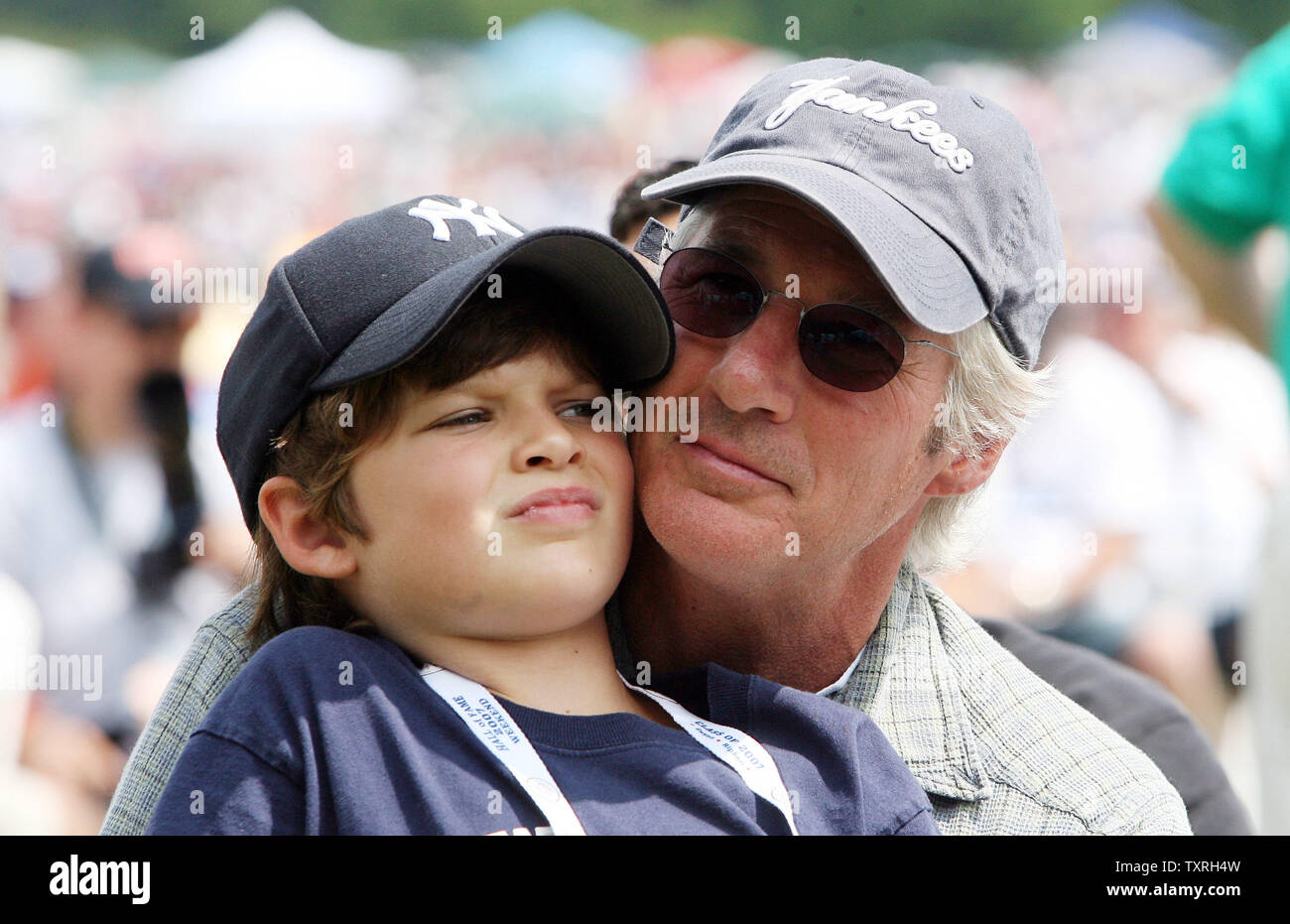Actor Richard Gere holds son Homer as they watch the National Baseball Hall of Fame's induction ceremonies in Cooperstown, New York on July 29, 2007.  (UPI Photo/Bill Greenblatt) Stock Photo