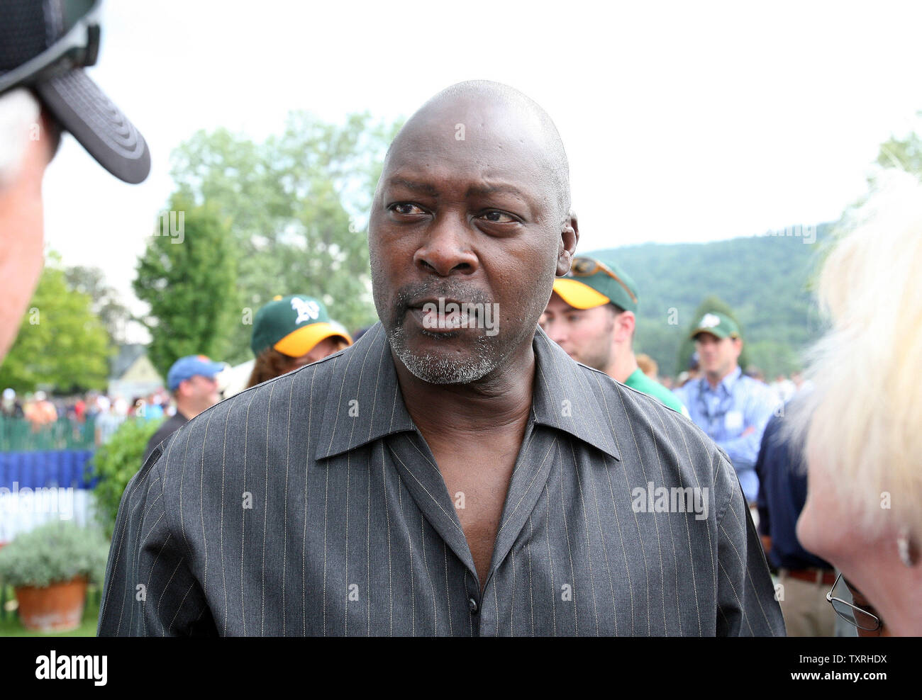 Former baseball player Dave Stewart talks with friends before the induction  ceremonies for National Baseball Hall of Fame inductees Rickey Henderson  and Jim Rice in Cooperstown, New York on July 26, 2009. (