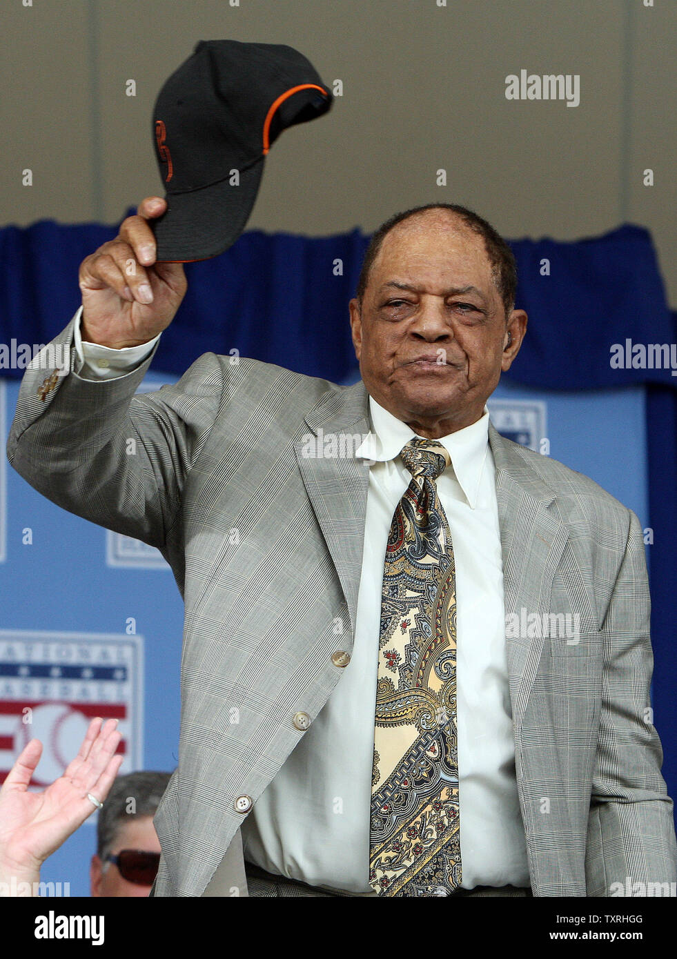 National Baseball Hall of Fame member Willie Mays waves his hat as he