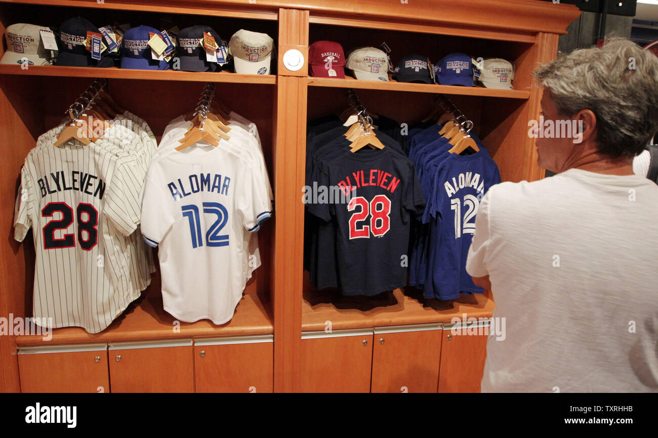 Visitors to the National Baseball Hall of Fame gift shop check out the new jerseys on sale for inductees Bert Blyleven and Roberto Alomar in Cooperstown, New York on July 21, 2011.
