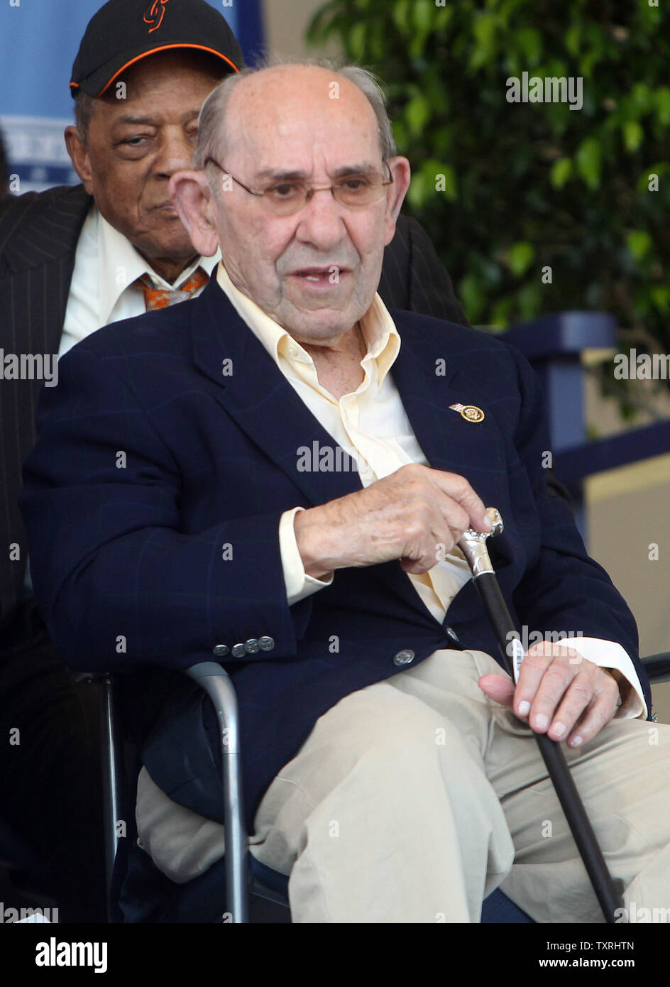 National Baseball Hall of Fame memeber Yogi Berra watches induction ceremonies from the stage in Cooperstown, New York on July 22, 2012. UPI/Bill Greenblatt Stock Photo