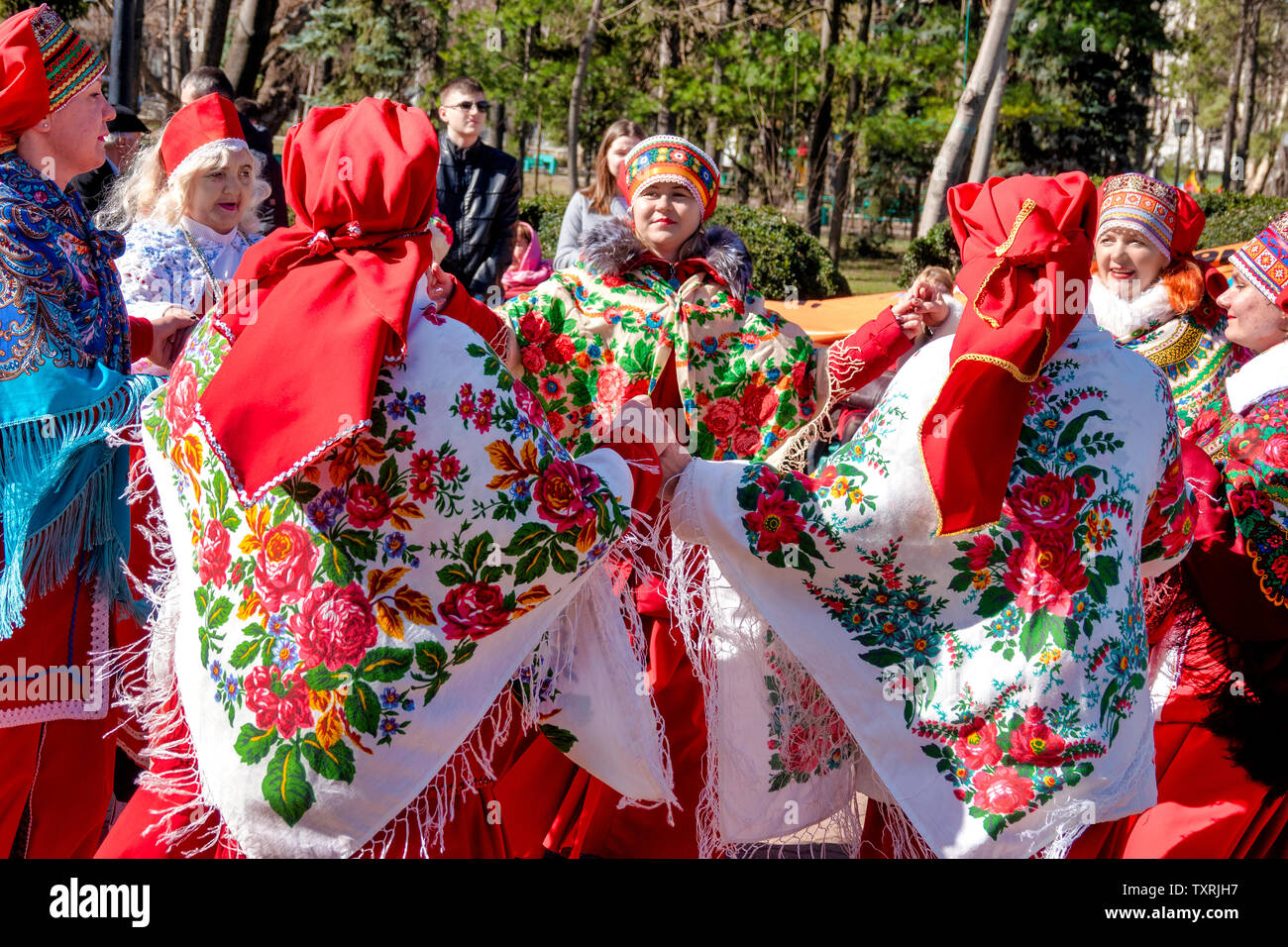Dancers in traditional Moldovan dress dance during the festival of Maslenitsa, an eastern slavic religious and folk holiday, in Chișinău, Moldova Stock Photo