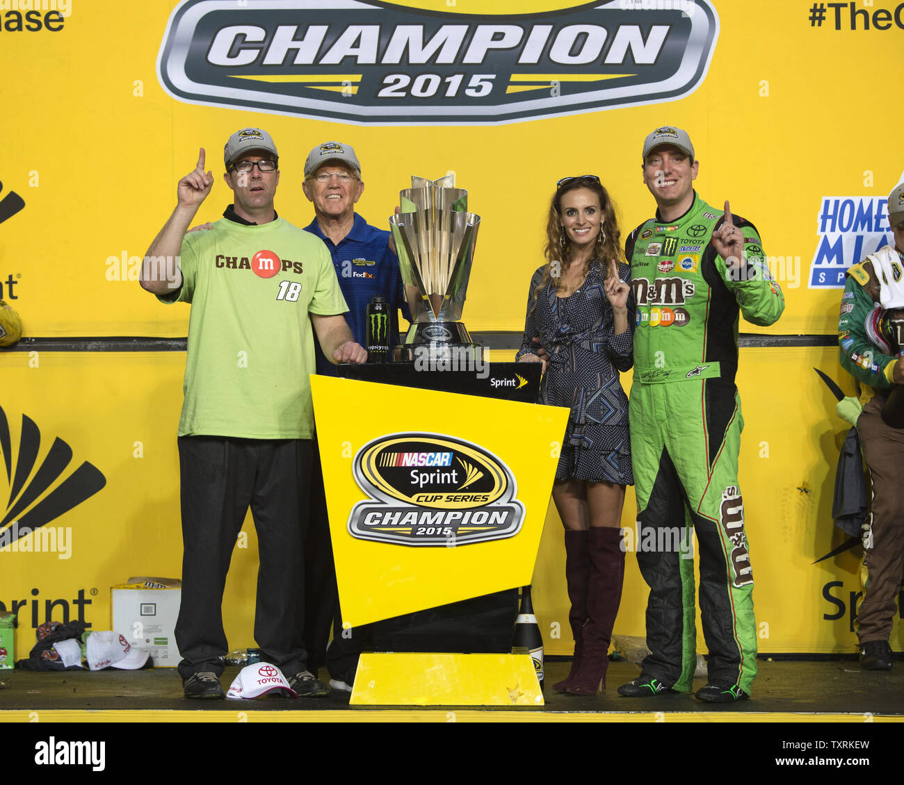Racer Kyle Busch R Driver For M M S Crispy Toyota Celebrate Winning The 2015 Nascar Sprint Cup Series Championship Along With Jd And Joe Gibbs L And His Wife Samantha At The Homestead Miami Speedway