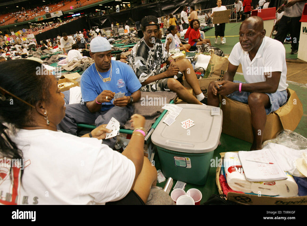 Irma Woolens (L), Andre Brown, Raydell Jasper, and Eugene Stewart, all from the St. Bernard neighborhood in New Orleans, Louisiana, play cards in the Astrodome in Houston, Texas on Friday, September 2, 2005. (UPI Photo/Chris Carson) Stock Photo
