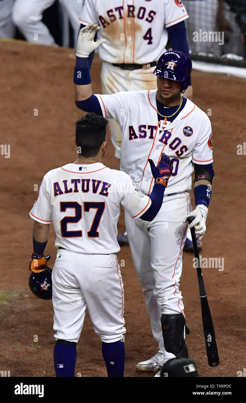 Houston Astros second baseman Jose Altuve (27) high fives teammate Yuli  Gurriel after hitting a game tying three-run home run against the Los  Angeles Dodgers in the fifth inning in the 2017
