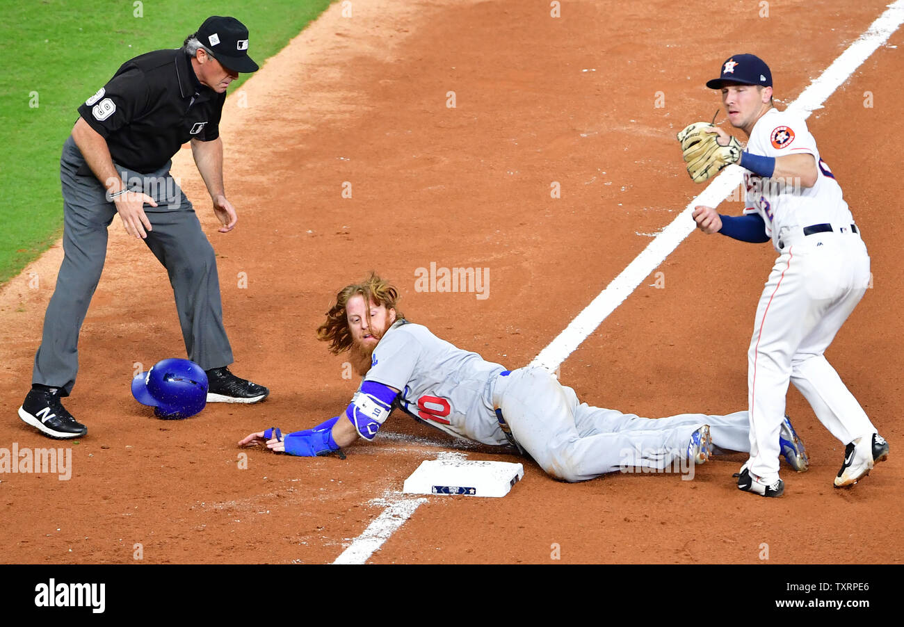 Houston Astros third baseman Alex Bregman tags out Los Angeles Dodgers  Justin Turner on a sacrifice bunt attempt in the seventh inning in the 2017  MLB World Series game five at Minute