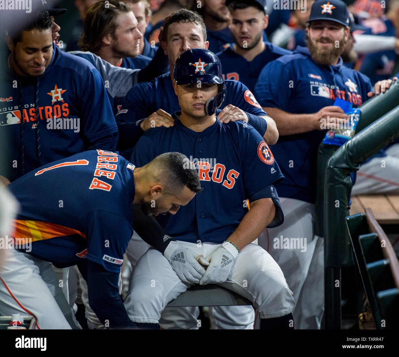 Houston Astros first baseman Aledmys Diaz receives a celebratory massage  from teammates Alex Bregman and Carlos Correa after hitting a three-run  home run against the Oakland Athletics in the 1st inning at