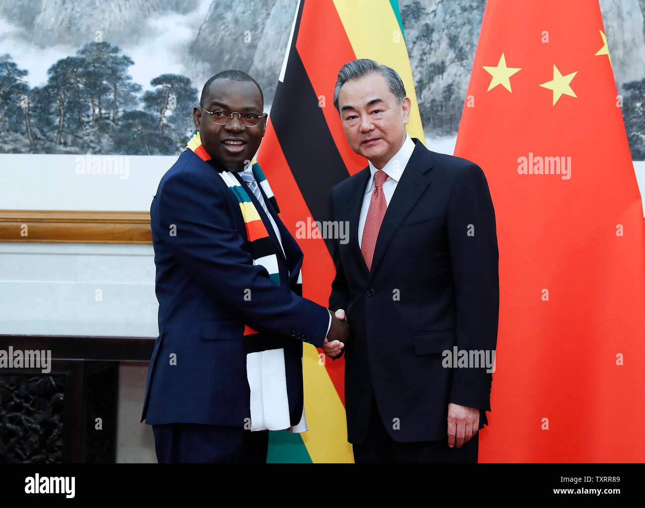 Beijing, China. 25th June, 2019. Chinese State Councilor and Foreign Minister Wang Yi (R) meets with Zimbabwe's Foreign Affairs and International Trade Minister Sibusiso Moyo in Beijing, capital of China, June 25, 2019. Credit: Liu Bin/Xinhua/Alamy Live News Stock Photo