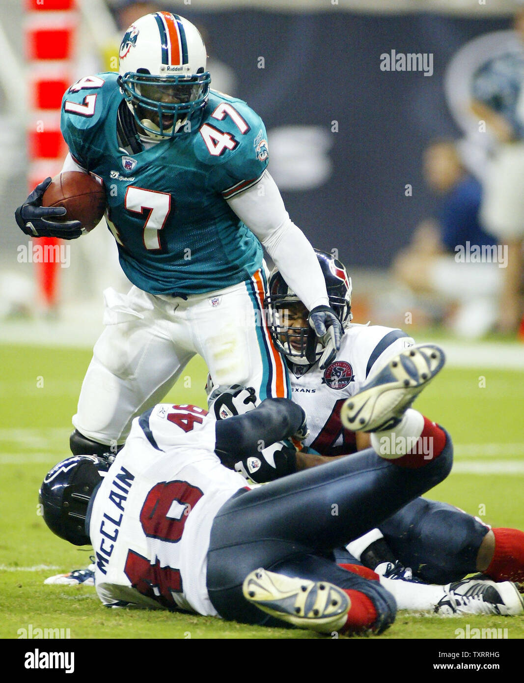 HOUP2002082405 - HOUSTON, Texas, March 5 (UPI) -  Miami Dolphin Zak Kustok (7) tries to evade the Houston Texans' defense during the first game played at Reliant Stadium on Aug. 24, 2002. Miami won the game 24-3.     mk/jm/Joe  MItchell        UPI Stock Photo