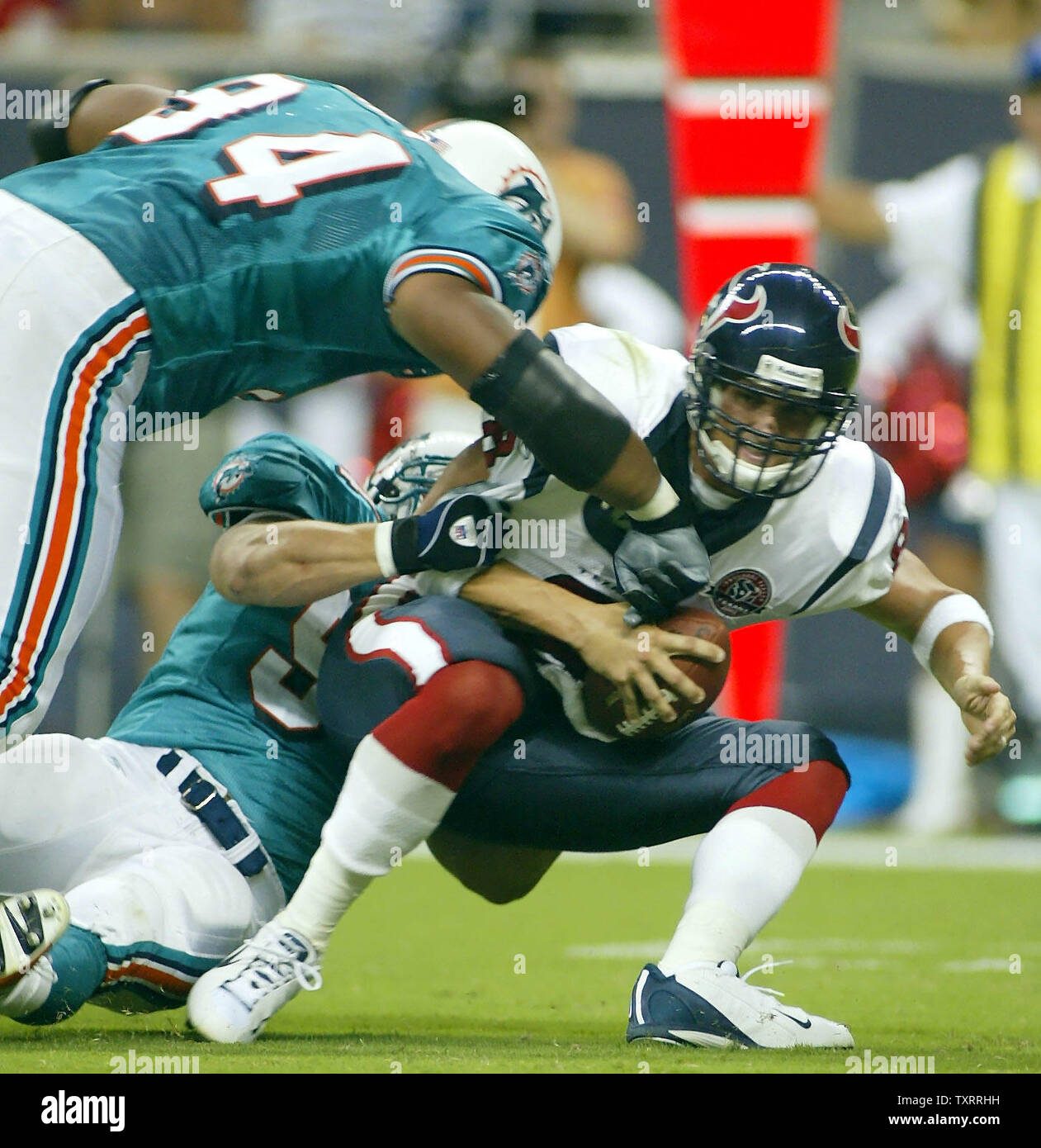 HOUP2002082404 - HOUSTON, Texas, March 5 (UPI) - Houston Texans' quarterback David Carr (8) gets sacked by the Miami defense during the 2nd quarter on Aug. 24, 2002. The Miami at Houston game was the first to be played in Reliant Stadium. Miami won the game 24-3.        mk/jm/Joe  MItchell             UPI Stock Photo