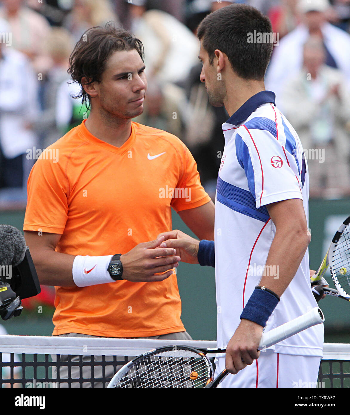 Spaniard Rafael Nadal (L) meets Serbian Novak Djokovic at the net after their mens final match at the BNP Paribas Open in Indian Wells, California on March 20, 2011.  Djokovic defeated Nadal 4-6, 6-3, 6-2 to win the tournament.   UPI/David Silpa Stock Photo