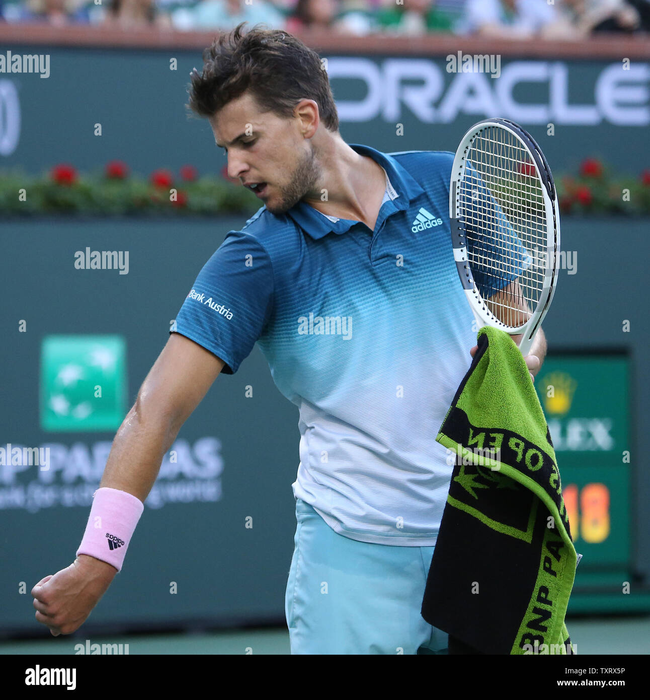 Dominic Thiem of Austria looks at his injured elbow during his men's final  match against Roger Federer of Switzerland at the BNP Paribas Open in Indian  Wells, California on March 17, 2019.