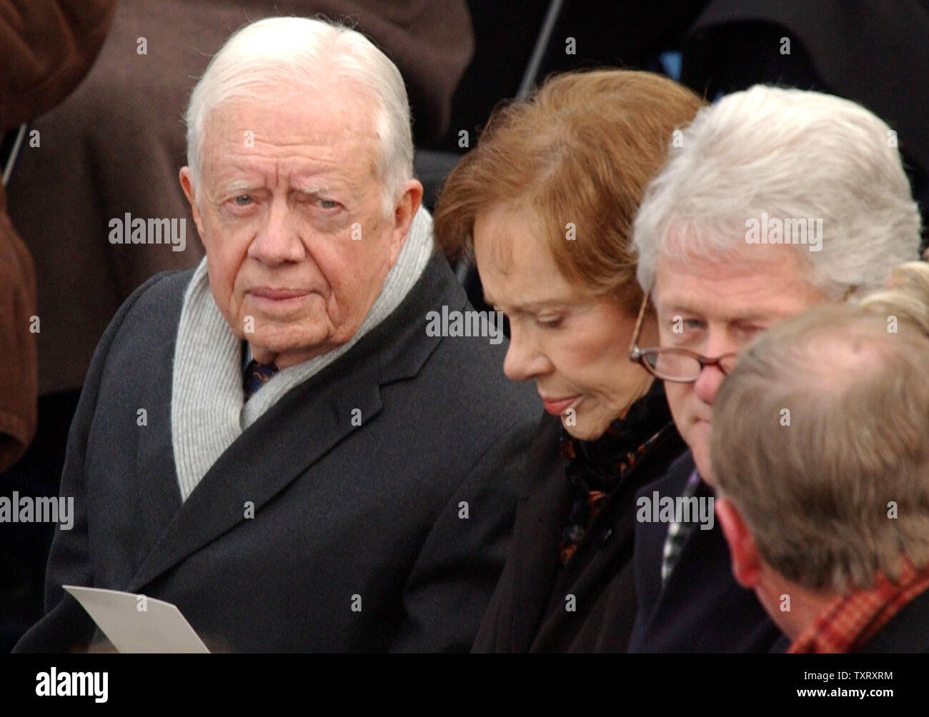 Former President Jimmy Carter, his wife Roslyn, and Former President Bill Clinton wait for the start of President George W. Bush's second inaugural ceremony on Capitol Hill in Washington on Jan. 20, 2005.   (UPI Photo/Roger L. Wollenberg) Stock Photo