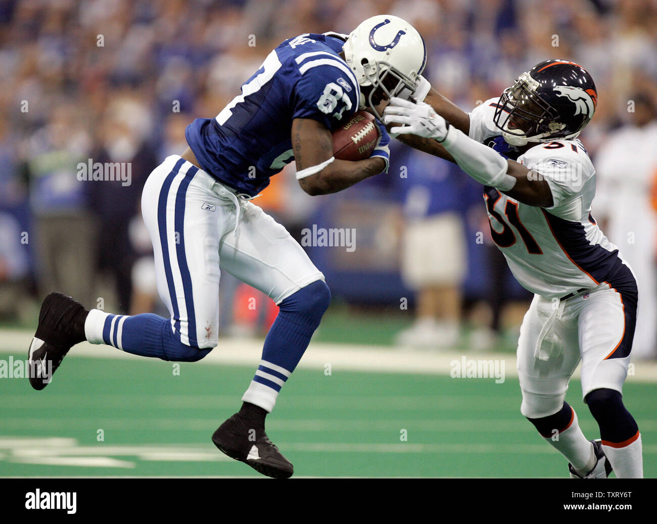 Denver Bronco's Kelly Herndon (31) tries to make a tackle on Indianapolis  Colt's Reggie Wayne (87) in the AFC wild card playoff at the RCA Dome in  Indianapolis, IN on January 9,