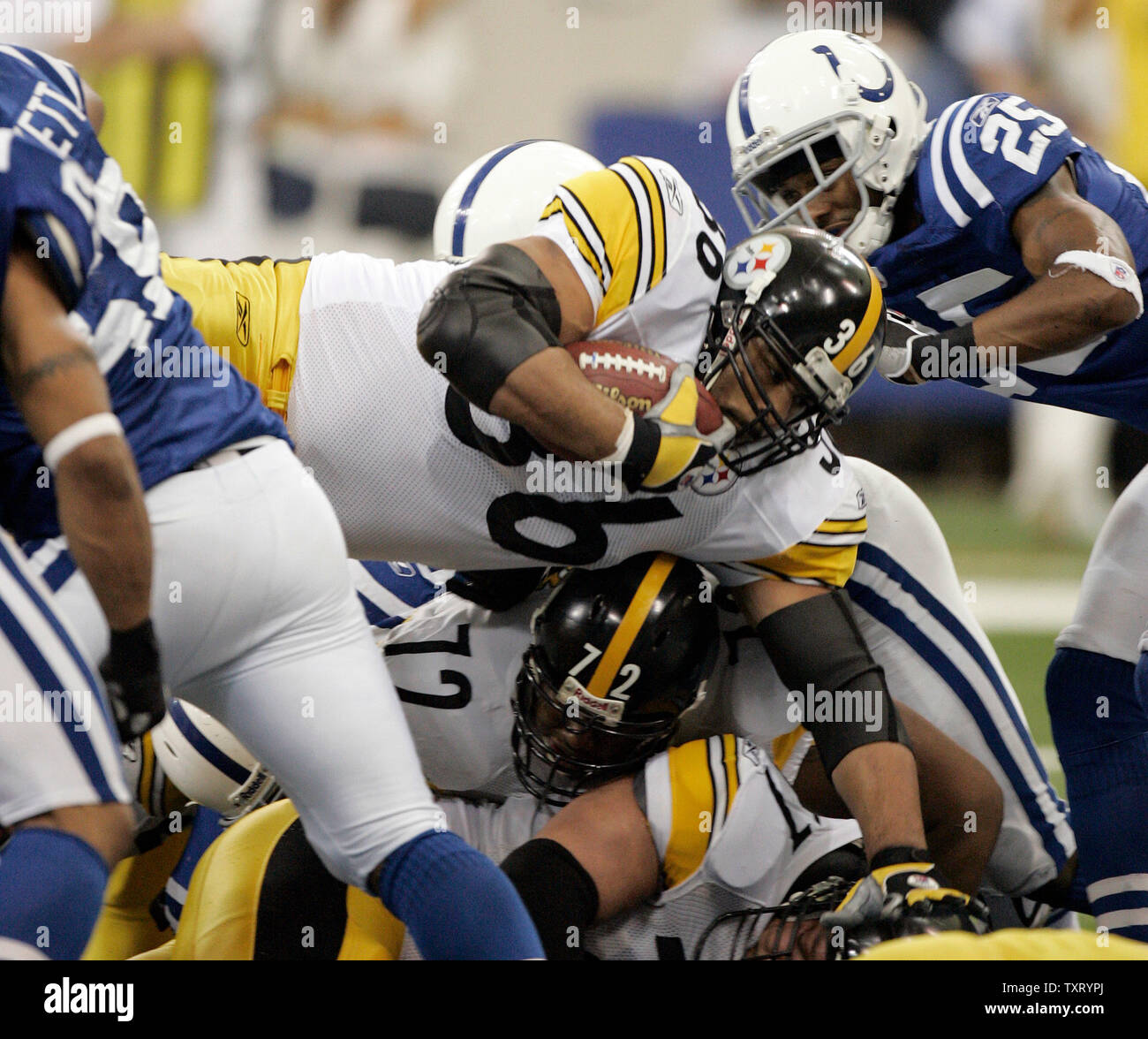 Pittsburgh Steelers running back Jerome Bettis (36) dives over the pile in front of Indianapolis Colts defensive back Nick Harper (25) to score a touchdown. The Steelers defeated the Colts 21-18 in their AFC Divisional playoff game at the RCA Dome in Indianapolis on January 15, 2006. (UPI Photo/Mark Cowan) Stock Photo