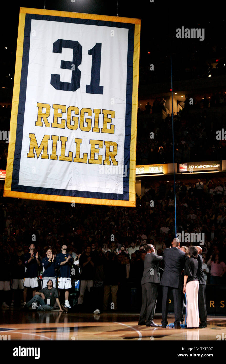 Former Indiana Pacer Reggie Miller and members of his family raise a #31  banner to the rafter during a ceremony to retire Miller's jersey at the  Pacers game against the Phoenix Suns