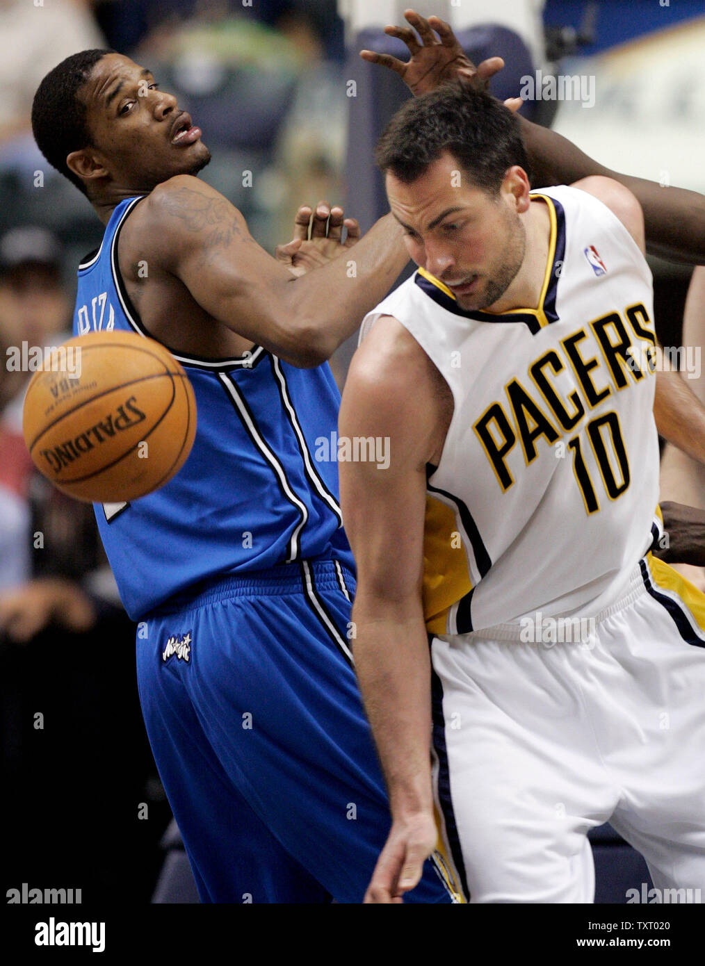 Indianapolis Pacers forward Jeff Foster (10) and Orlando Magic forward Trevor Ariza (1) watch a loose ball during the second half at Conseco Fieldhouse in Indianapolis, In April 19, 2006. (UPI Photo/Mark Cowan) Stock Photo