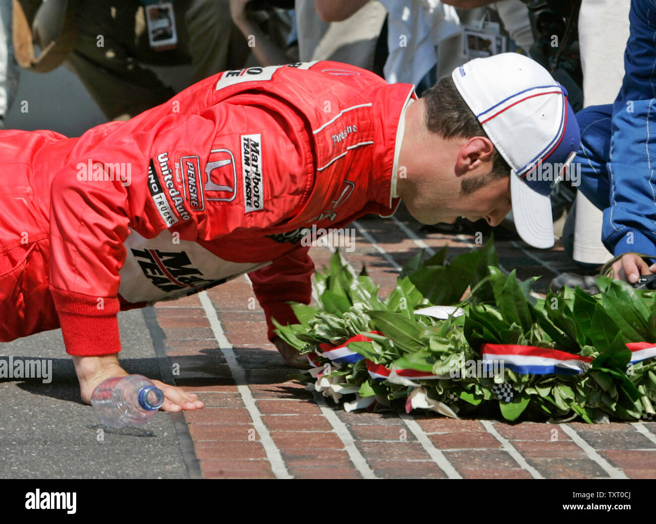 Sam Hornish Jr. kisses the yard of bricks at the finish line after winning the 90th running of the Indianapolis 500 on May 28, 2006 in Indianapolis, IN. Hornish edged out Marco Andretti in the second closest Indy 500 finish. (UPI Photo/Brian Kersey) Stock Photo