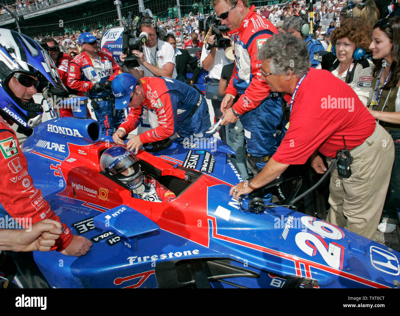 Mario Andretti, right, greets his grandson Marco after he finishes the 90th running of the Indianapolis 500 on May 28, 2006 in Indianapolis, IN. Andretti finished second in the race, beaten by Sam Hornish Jr. in the second closest Indy 500 finish. (UPI Photo/Brian Kersey) Stock Photo