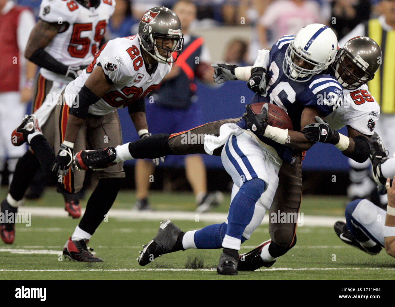Indianapolis Colts running back Kenton Keith (36) is brought down by Tampa Bay Buccaneers linebacker Derrick Brooks (55) and cornerback Ronde Barber (20) after a 22-yard gain in the fourth quarter at the RCA Dome in Indianapolis on October 7, 2007. The Colts defeated the Buccaneers 33-14 to remain undefeated on the season. (UPI Photo/Mark Cowan) Stock Photo