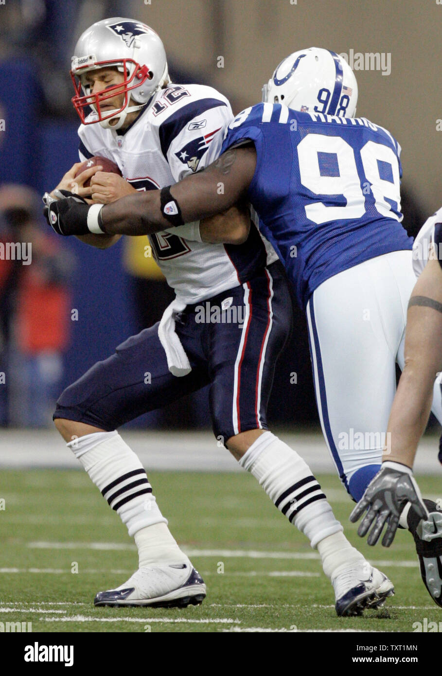 Indianapolis Colts defensive end Robert Mathis (98) sacks New England  Patriots quarterback Tom Brady (12) for a 10-yard loss during the first  quarter at the RCA Dome in Indianapolis on November 4,