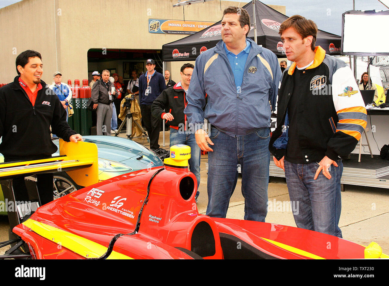 Mike Golic and Mike Greenberg of ESPN's Mike and Mike in the morning show,  look over an Indy Light's car on May 23, 2008 at the Indianapolis Motor Speedway in Indianapolis, Indiana. (UPI Photo/ Ed Locke) Stock Photo