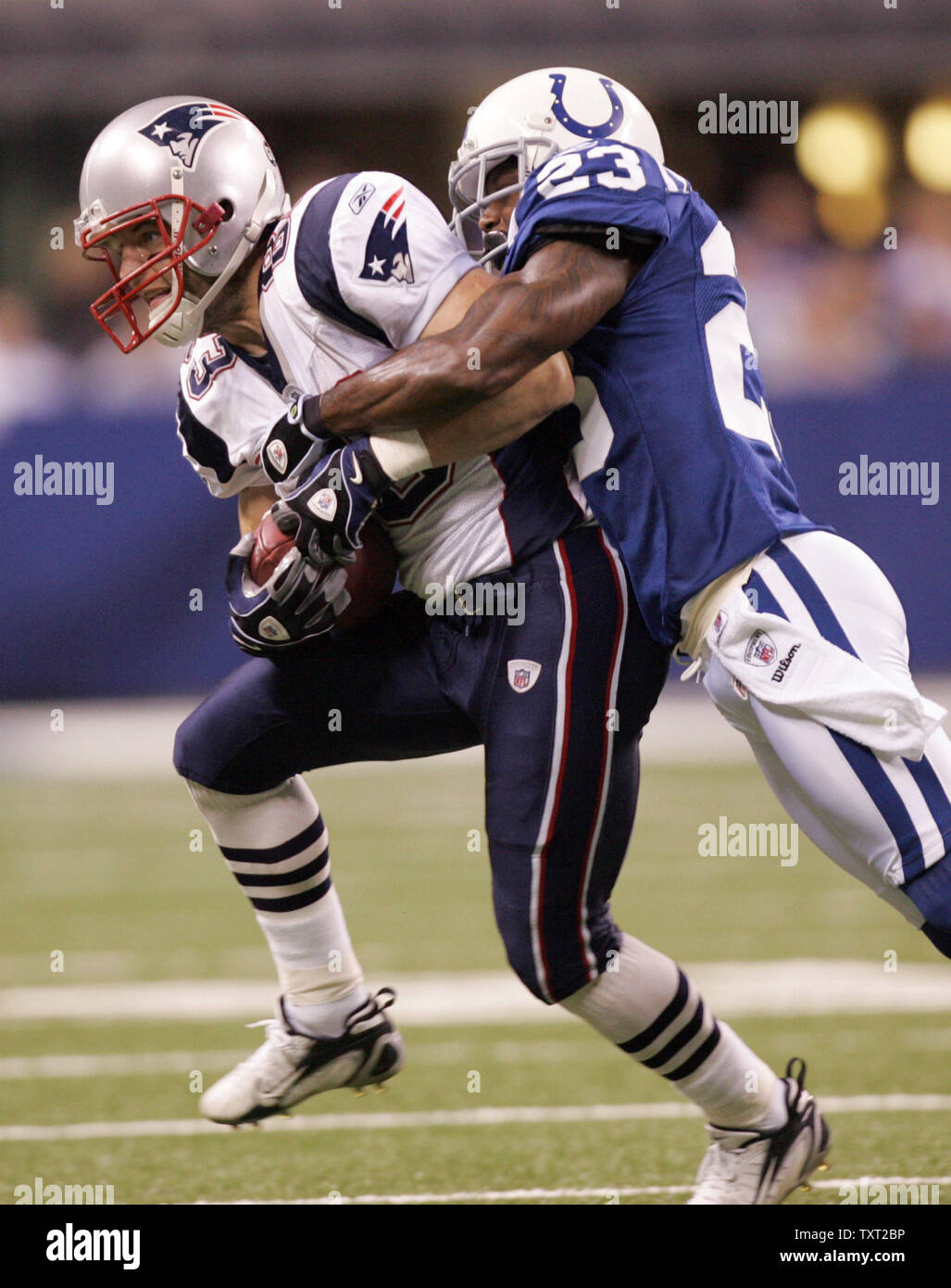 New England Patriots wide receiver Randy Moss (81) makes a 4-yard touchdown  catch in front of Indianapolis Colts defensive back Tim Jennings (23)  during the second quarter at the RCA Dome in