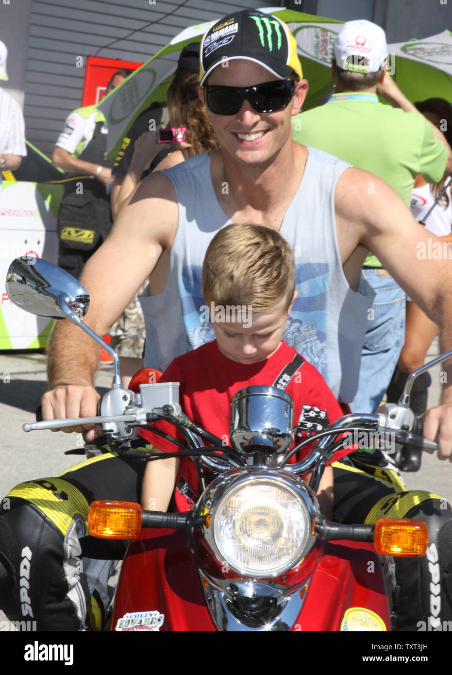 Colin Edwards rides through the pits with his son Hayes before Qualifying the Moto GP at the Indianapolis Motor Speedway  on August 28, 2010in Indianapolis, In. UPI /Ed Locke Stock Photo