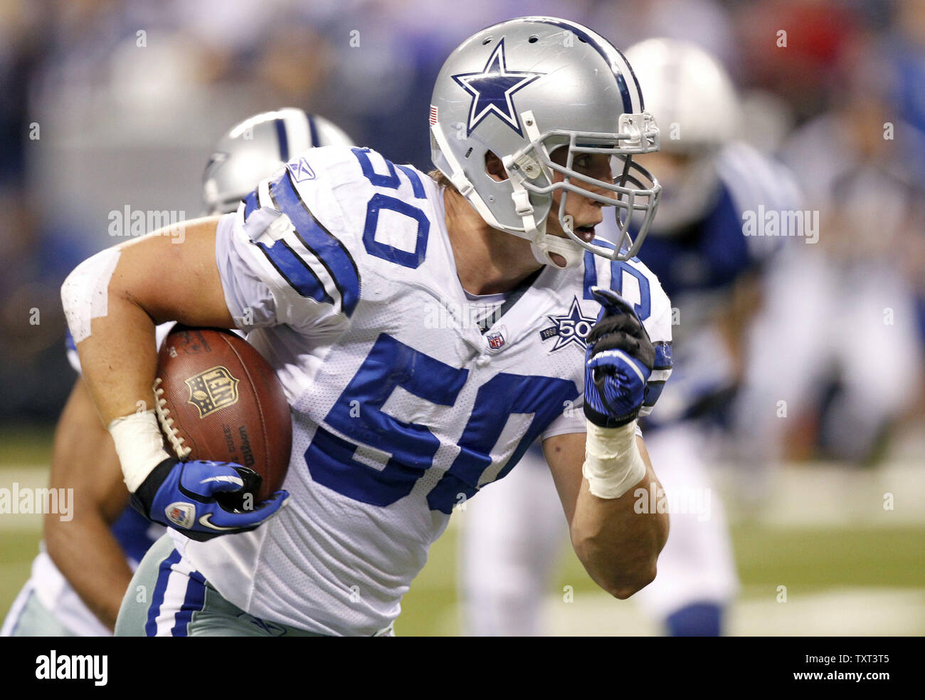 Dallas Cowboys linebacker Sean Lee (5) returns an interception 31-yards for  a touchdown during the third quarter of the Cowboys 38-35 overtime win over  the Indianapolis Colts at Lucas Oil Field in