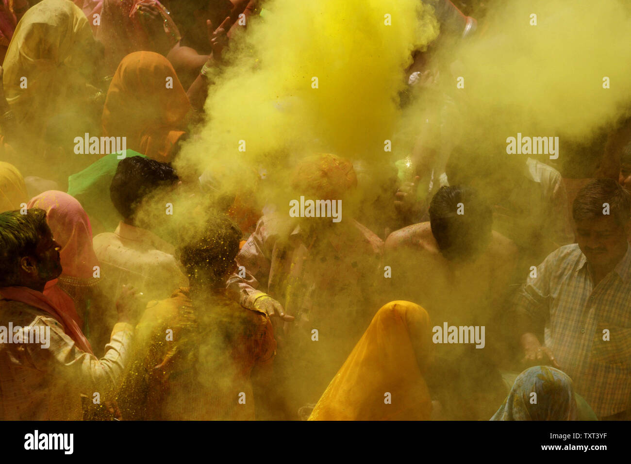 Hindu devotees throw colored powder while celebrating 'Holi,' the ...
