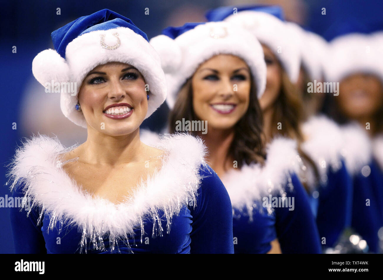 Indianapolis Colts cheerleader Megan M., who shaved her head in support of  head coach Chuck Pagano who is suffering from leukimia, leads the the squad  in Christmas attire during their game against