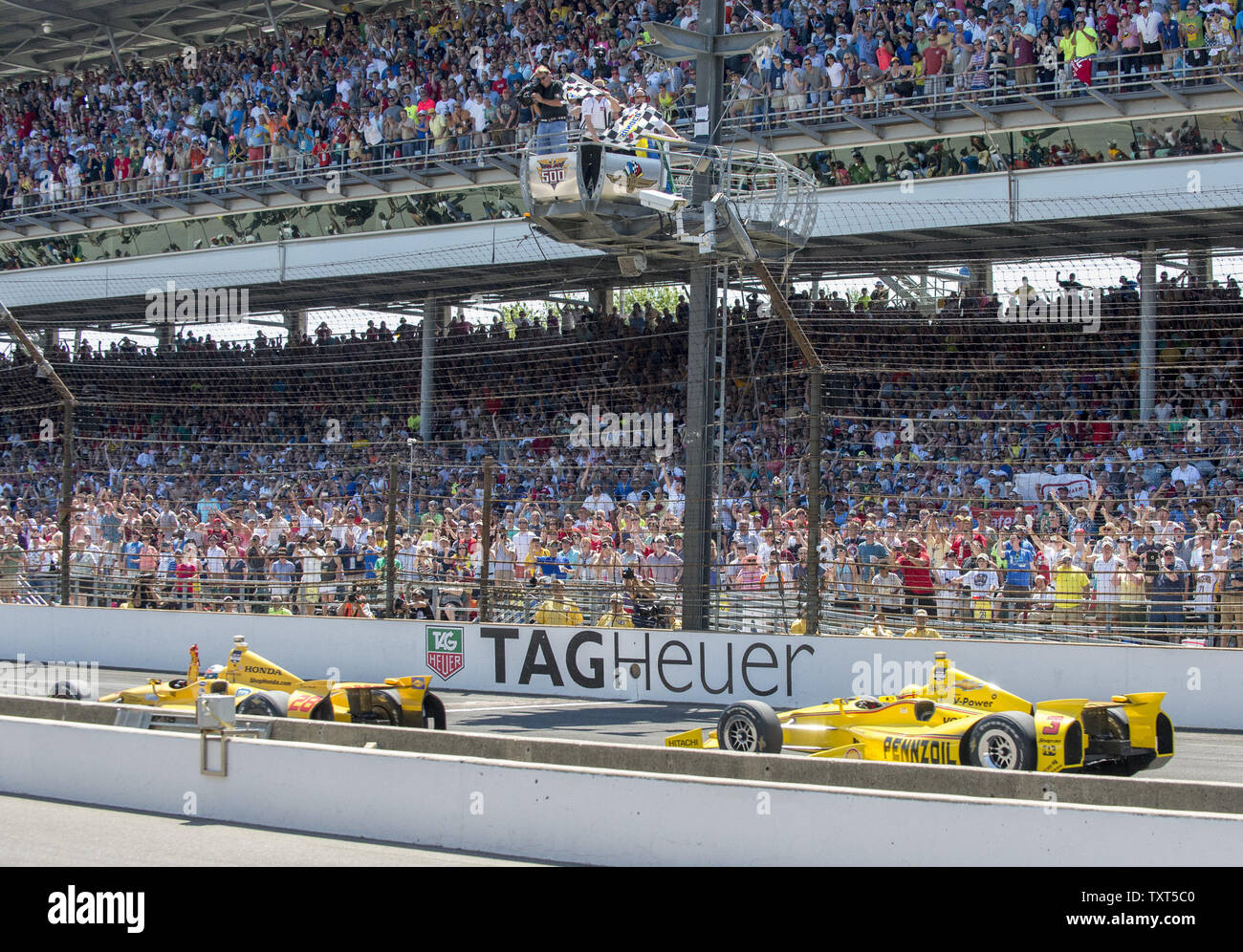 Ryan Hunter-Reay crosses the finish line just ahead of Helio Castroneves after they battled for the lead after a red flag stopped with race in the last few laps in the closing moments during the Indianapolis 500 at Indianapolis Motor Speedway in Indianapolis, on May 25, 2014.  UPI /Darrell Hoemann Stock Photo