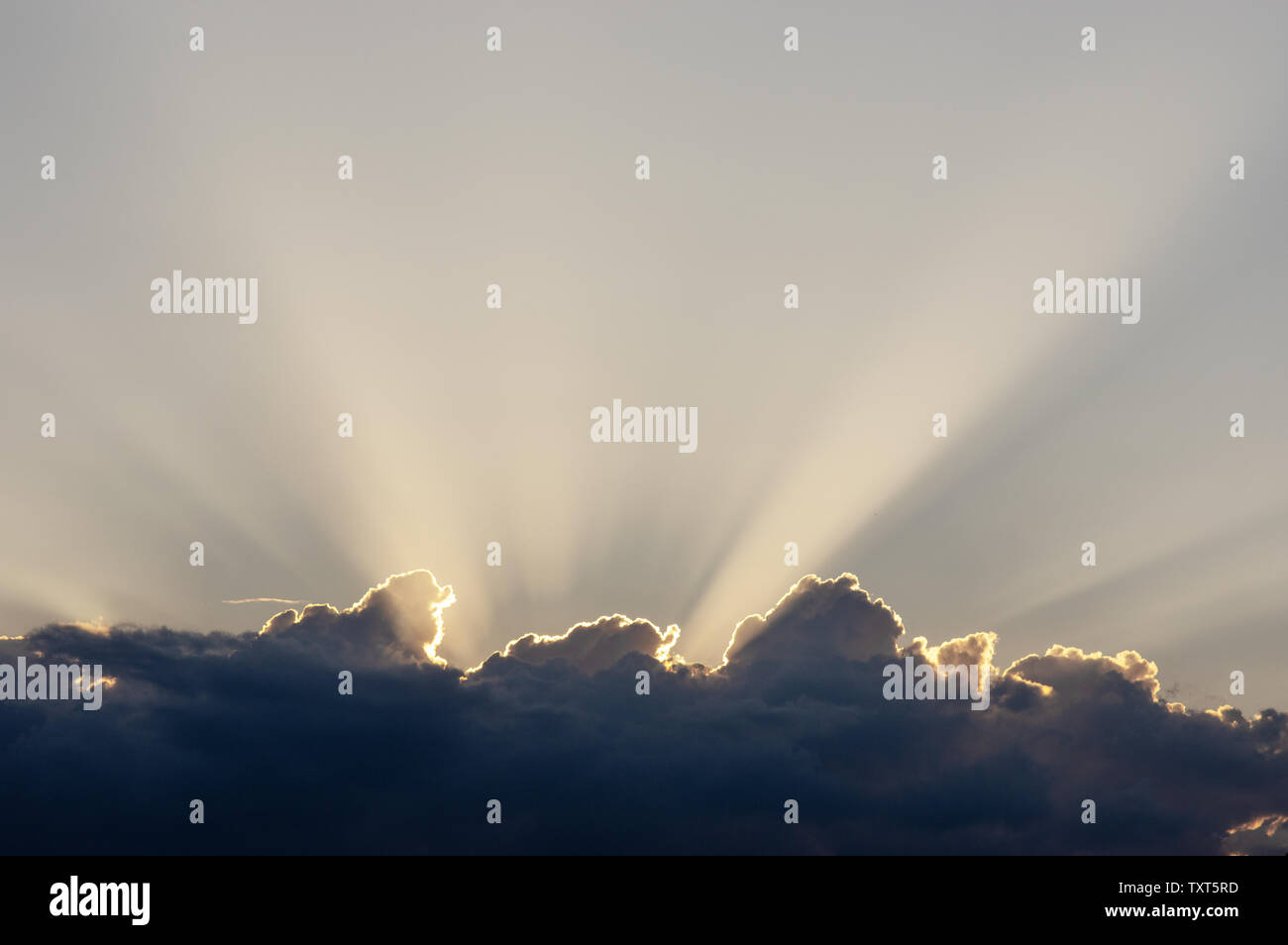 Sun behind a cloud, with cloud rays Stock Photo