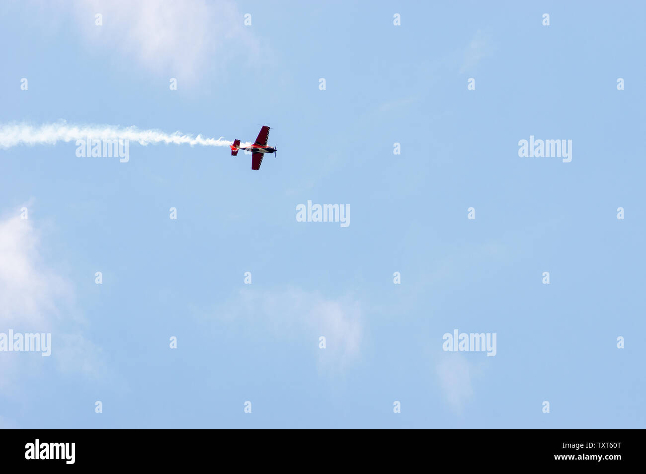 Propeller plane with a smoke contrail performing at an airshow Stock