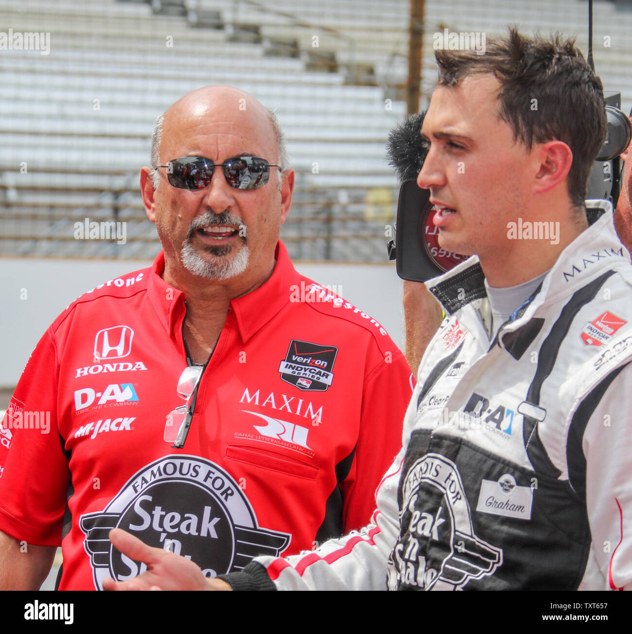 1986 Indy 500 winner Bobby Rahal and his son Graham Rahal discuss how Graham's run went on pole day qualifications for the 99th running of the Indianapolis 500 at the Indianapolis Motor Speedway on May 17, 2015 in Indianapolis, Indiana.  Rahal will start 17th on the grid.   Photo by Ed Locke/UPI Stock Photo