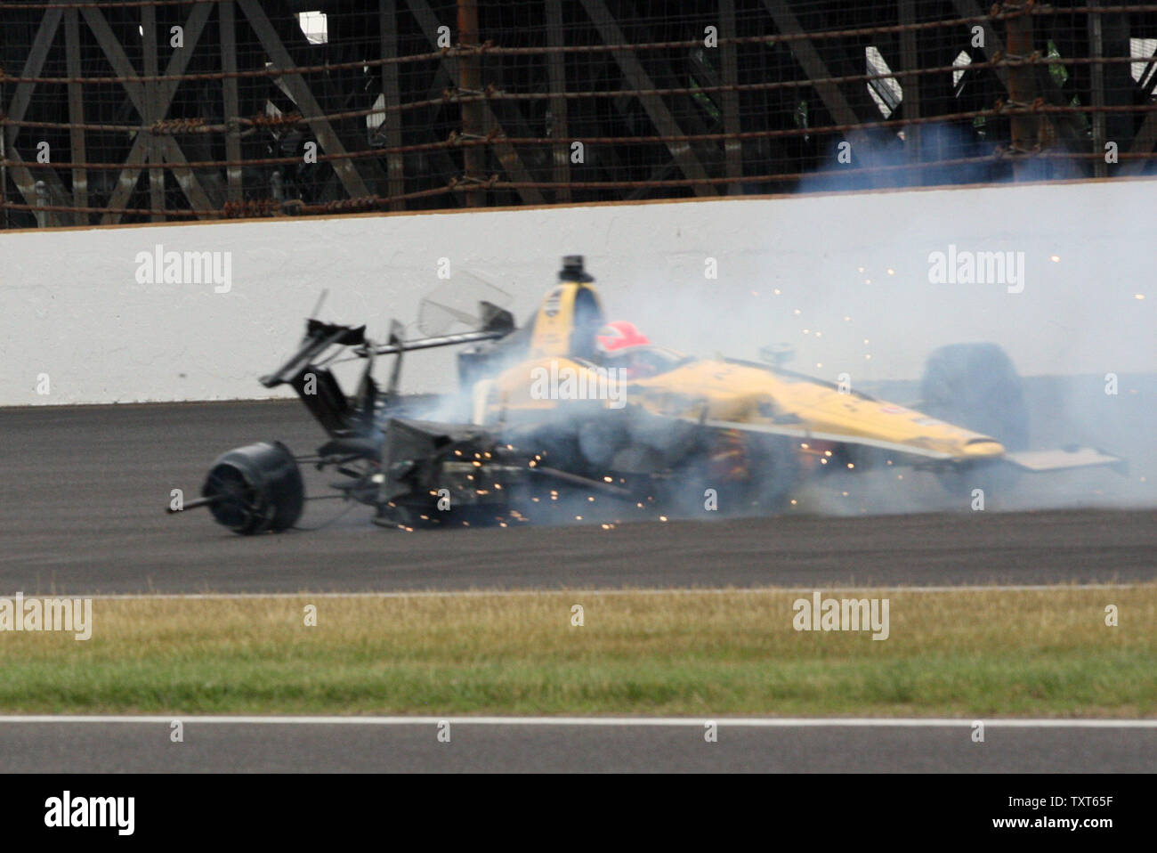 Indy Car driver James Hinchcliffe slides along the track after hitting