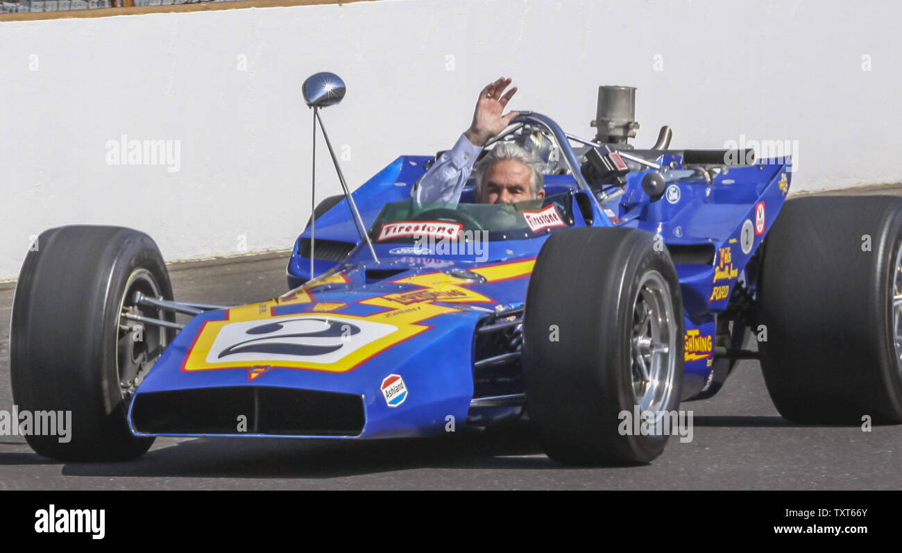 Four time Indy 500 winner Al Unser waves to fans during a parade lap on