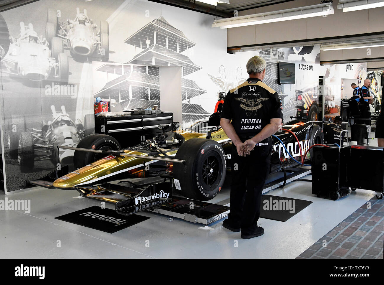 Crew members for driver James Hinchcliffe prepare his race car in the