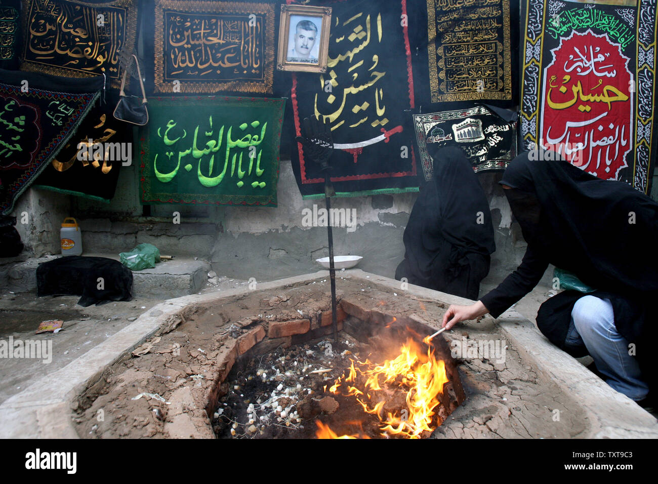 Chad Islam Ritual Women wearing chadors light candles during an Islamic mourning ceremony ...
