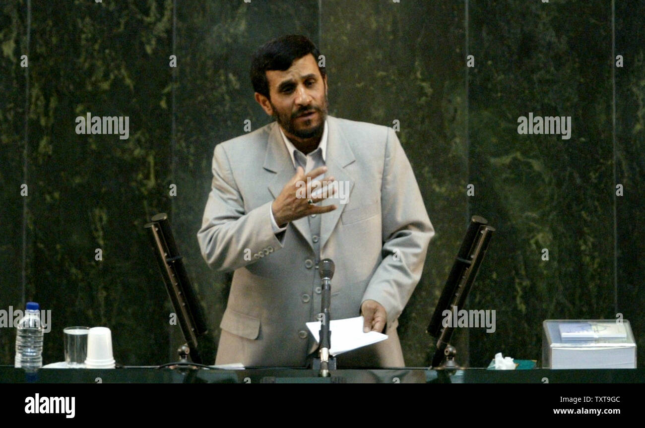 Iran's president Mahmoud Ahmadinejad delivers his speeches about budget bill in parliament as the paket of budget bill is seen near his hand (R) in Tehran, Iran on January 15, 2006. Iranian President Mahmoud Ahmadinejad said his nation has no intention of building nuclear weapons amid rising international concern that the Islamic nation's uranium enrichment research is a front for developing atomic bombs.(UPI Photo/Mohammad Kheirkhah) Stock Photo