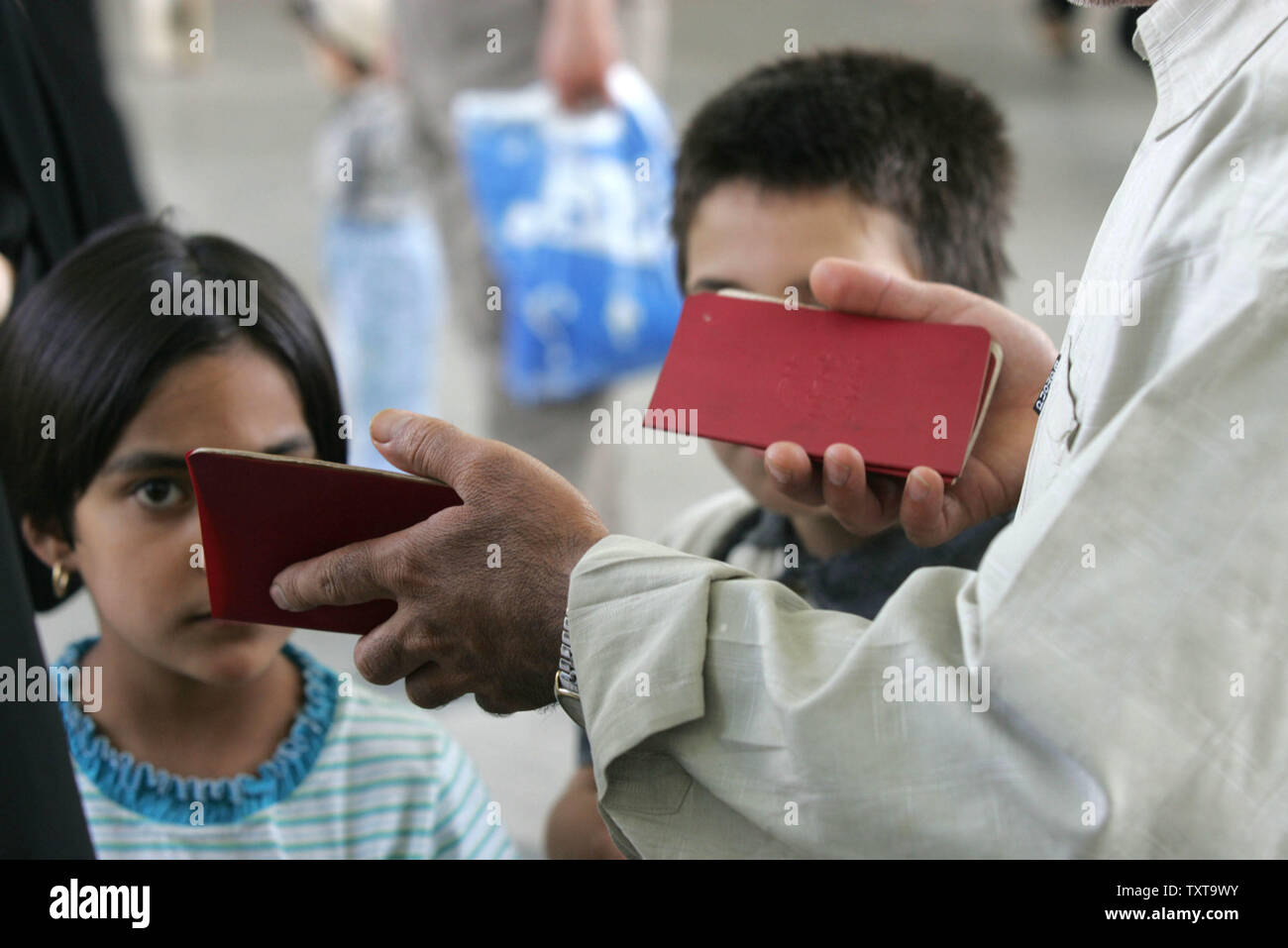 Iranian voters have their ID's checked as they queue to vote at a polling station in Tehran on June 24, 2005.  The historic runoff presidential election matches moderate Ayatollah Hashemi Rafsanjani and hard-liner Mahoud Ahmadinejad. (UPI Photo/Reza Madadi) Stock Photo