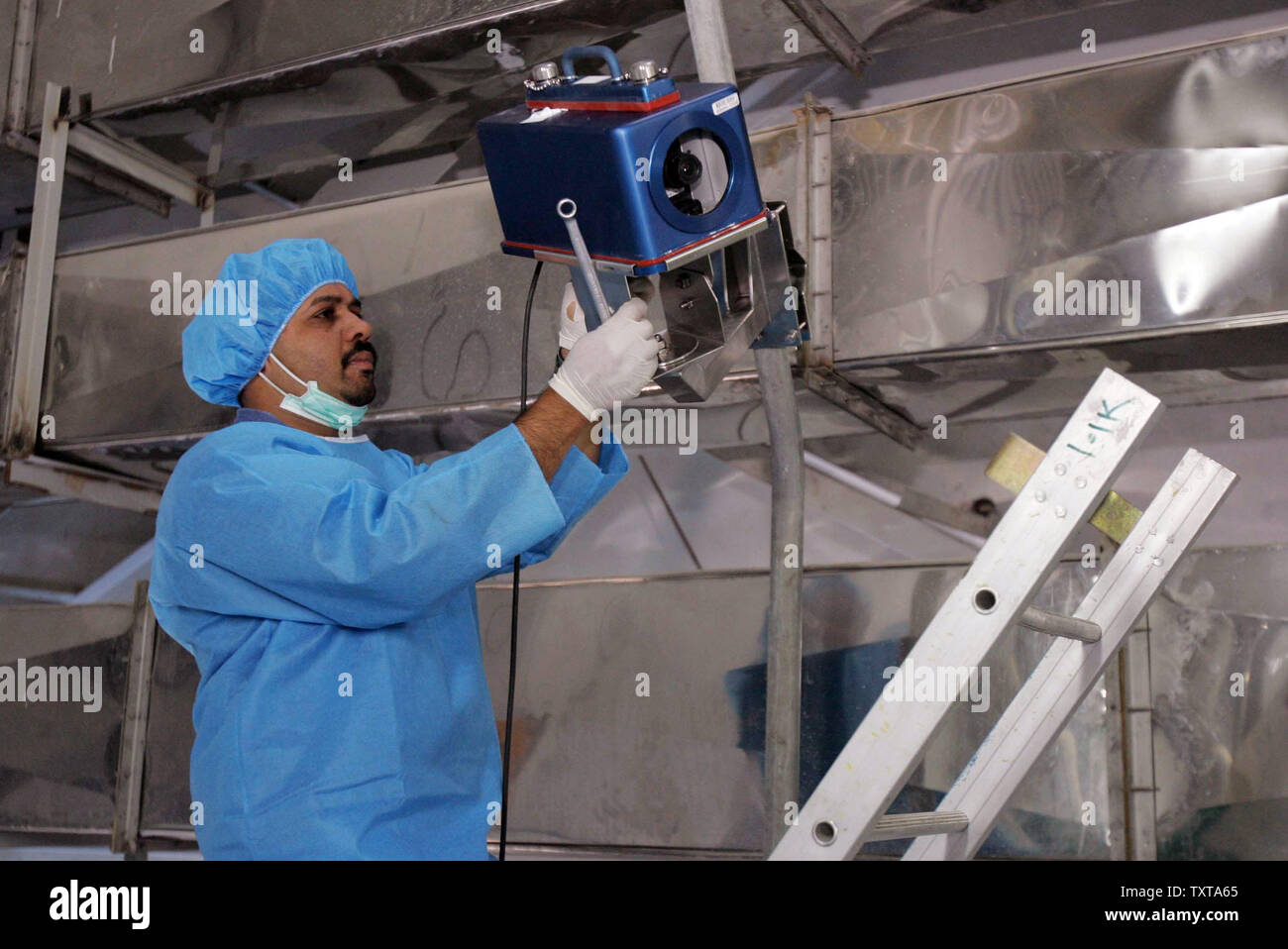 An inspector of the International Atomic Energy Agency (IAEA) installs