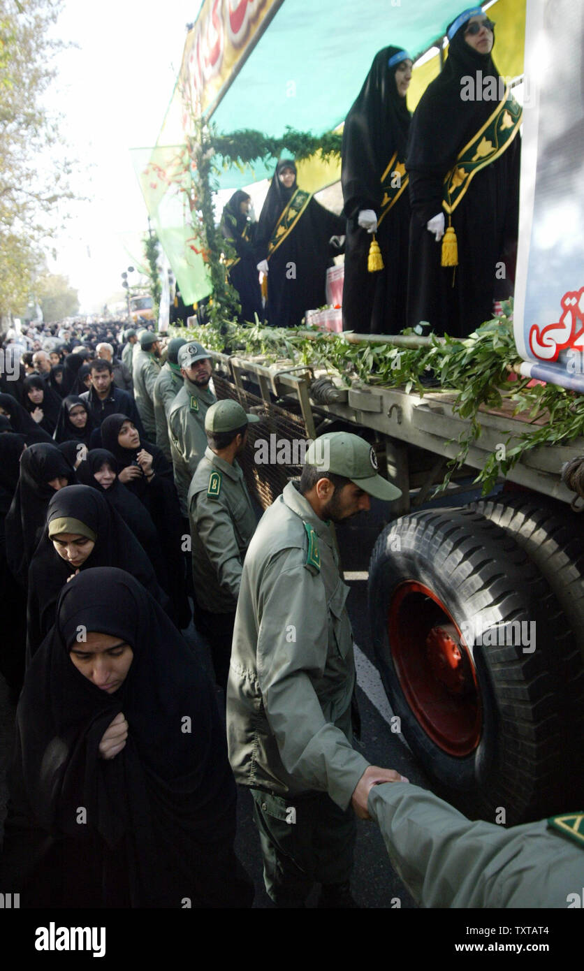 Iranian soldiers circle a truck carrying the dead during a funeral ceremony for 110 people that were killed during the 8-year Iran-Iraq war, whose bodies were finally recovered after 17 years, in Tehran, Iran, on November 25, 2005.   (UPI Photo/Mohammad Kheirkhah) Stock Photo