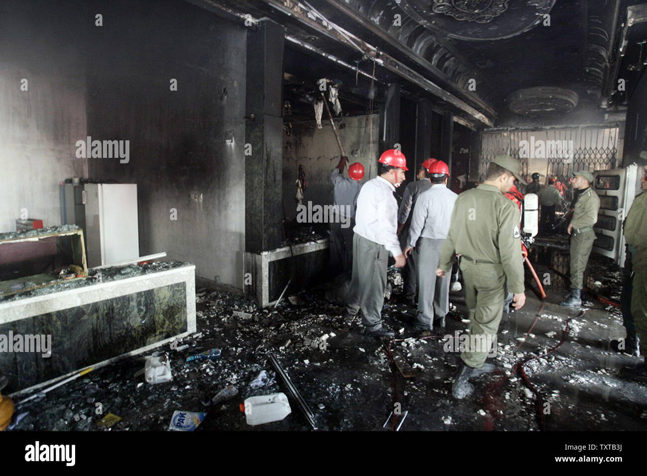 Iranian firemen look at the damage caused by a  bomb explosion in the Saman Bank in Ahvaz, Iran 1000 km south of Tehran on January 24,2006. Two bombs killed four people in the oil-rich southwestern city of Ahvaz in Khuzestan province, near the border with Iraq, state television reported. (UPI Photo/Amir Kholousi/Iranian Student News Agency/Isna) Stock Photo