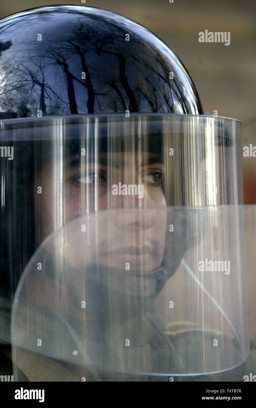 An Iranian riot police stands guard during demonstration in front of the Danish Embassy to support Iran's nuclear program and to protest a Danish newspaper cartoon that is being received as an insult to the Prophet Mohammed after weekly fridays prayer in Tehran, Iran, February 10, 2006.   (UPI Photo/Mohammad Kheirkhah) Stock Photo